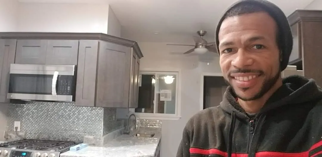 Gary smiling in a finished kitchen remodel